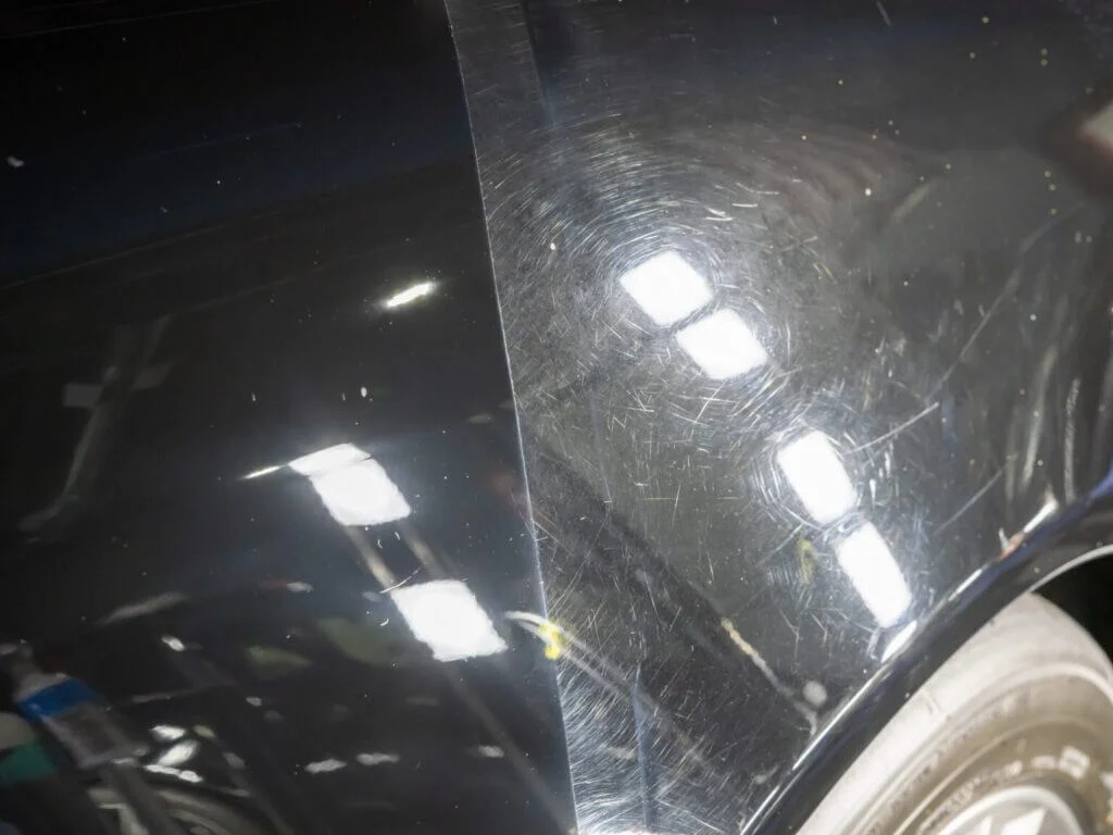 Swirl marks on black paint under LED light before and after paint correction